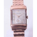 Longines, a gents mid size rectangular cased rose colour (gold filed) wristwatch, integral expanding