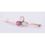 A 9ct rose gold bar brooch set with two white cabochon cut oval opals, measuring approx. 6.5mm x 4.