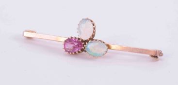A 9ct rose gold bar brooch set with two white cabochon cut oval opals, measuring approx. 6.5mm x 4.