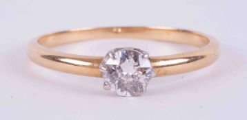 An 18ct yellow & white gold (no hallmarks and not tested) solitaire ring set with an older cut round