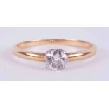 An 18ct yellow & white gold (no hallmarks and not tested) solitaire ring set with an older cut round