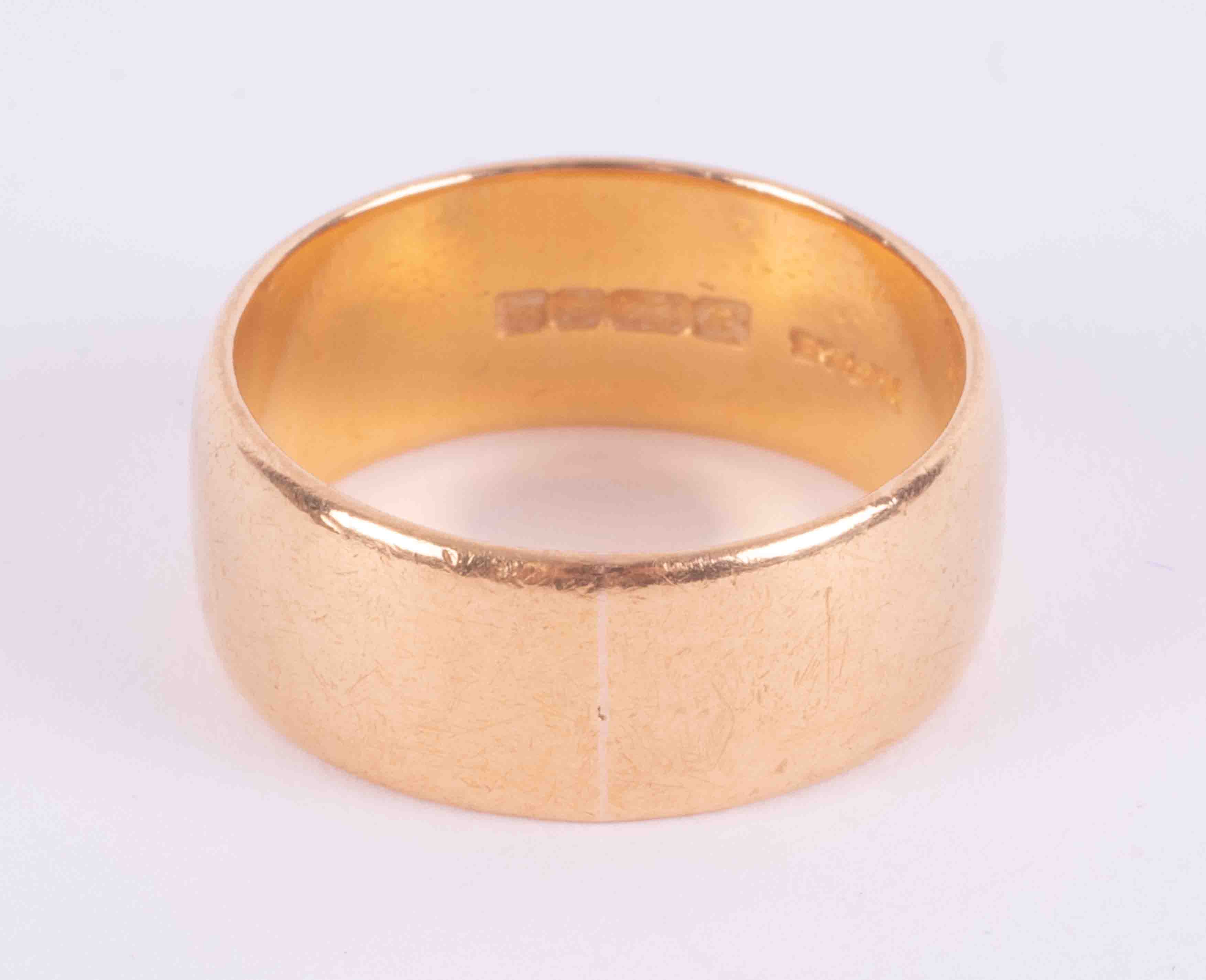 A 22ct yellow gold wedding band, 9.58g, approx. 8mm width, size P 1/2.