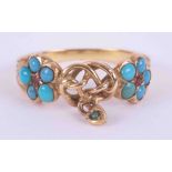 A yellow gold ring with engraved shoulders (not hallmarked) set with turquoise & two small rubies