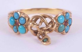A yellow gold ring with engraved shoulders (not hallmarked) set with turquoise & two small rubies