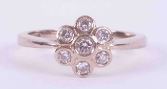 An 18ct white gold flower cluster style ring set with approx. 0.24 carats total weight of round