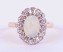 An 18ct yellow gold cluster ring set with a cabochon cut white opal, measuring approx. 9mm x 7mm,