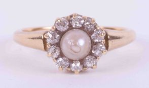 An 18ct yellow gold (not hallmarked or tested) antique ring set with a central pearl surrounded by