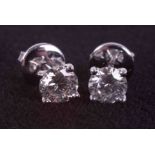 A pair of 18ct white gold four claw studs set with approx. 1.20 carats of round brilliant cut