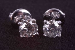 A pair of 18ct white gold four claw studs set with approx. 1.20 carats of round brilliant cut