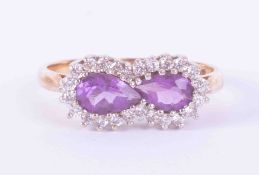 A 9ct yellow & white gold cluster ring set two pear shaped amethysts weight approx. 0.85 carats