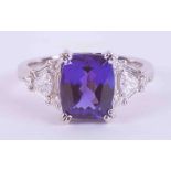 An impressive 18ct white gold ring set with a central cushion cut Tanzanite approx. 3.35 carats, AAA