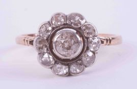 An antique 18ct rose & white gold flower cluster style ring set with eleven old round cut