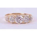 An 18ct yellow gold (no hallmarks) Edwardian ring set with five old round cut diamonds, approx.