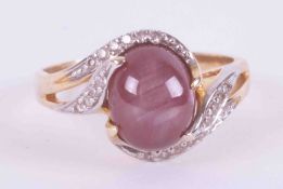 A 14ct yellow gold ring set with a cabochon cut ruby showing some asterism measuring approx. 9.5mm x