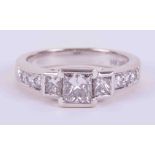 A 14ct white gold ring set with three princess cut diamonds, total weight approx. 0.86 carats with