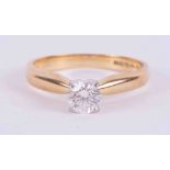 An 18ct yellow & white gold four claw solitaire ring set with 0.42 carats of round brilliant cut