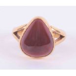 A 22ct yellow gold ring set with a pear shaped cabochon cut garnet, measuring approx. 15mm x 13mm,
