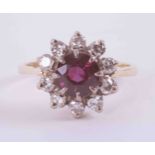 An 18ct yellow gold cluster ring set with approx. 1.00 carat of round cut ruby surrounded by approx.