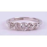 A platinum ring set with five older cut round diamonds, total weight approx. 0.85 carats, colour H-I