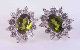 A pair of 9ct white gold cluster earrings set with 1.95 carats of oval cut green chrome diopside