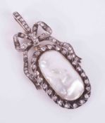 A large Victorian yellow & white gold ornate bow design brooch/pendant set with an oval pearl