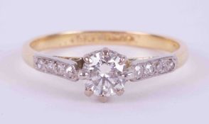 An 18ct yellow gold & platinum ring set with a central round cut diamond approx. 0.35 carats with