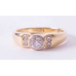An 18ct yellow & white gold ring with a central rub-over set round brilliant cut diamond, approx.
