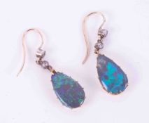 A pair of antique rose, yellow & white gold drop earrings set with oval cut black opals, measuring