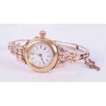 An antique 18ct & 9ct yellow & rose gold ornate bangle watch with push in clasp & safety chain, (
