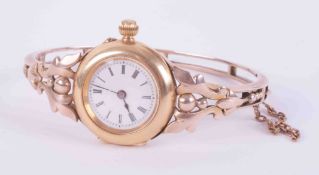 An antique 18ct & 9ct yellow & rose gold ornate bangle watch with push in clasp & safety chain, (