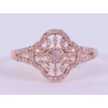 A 9ct rose gold flower open filigree design ring set 0.36 carats of pink round brilliant cut