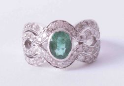 An 18ct white gold Art Deco style ring set with central oval cut emerald approx. 1.25 carats (