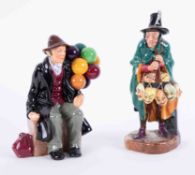 A Royal Doulton 'The Balloon Man', HN1954 together with 'The Mask Seller', HN2103 (2).