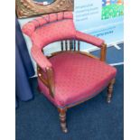 A traditional upholstered and wood framed tub armchair.