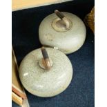 Two heavy curling stones.