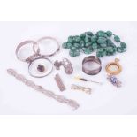 A bag of costume jewellery to include green hardstone beads, silver bangles, gilt metal pendant