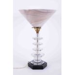 An Art Deco table lamp comprising black six sided solid base and five graduated matching clear glass