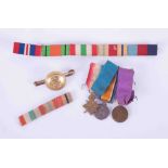 A miniature trio of Great War medals together with a Military badge brooch with ribbons.