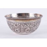 A Continental silver sugar bowl with embossed decoration, 86gms.
