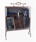 An Antique mirror fronted and etched brass fire screen.
