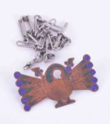 An Arts & Crafts style copper peacock brooch together with a silver guard albert chain.