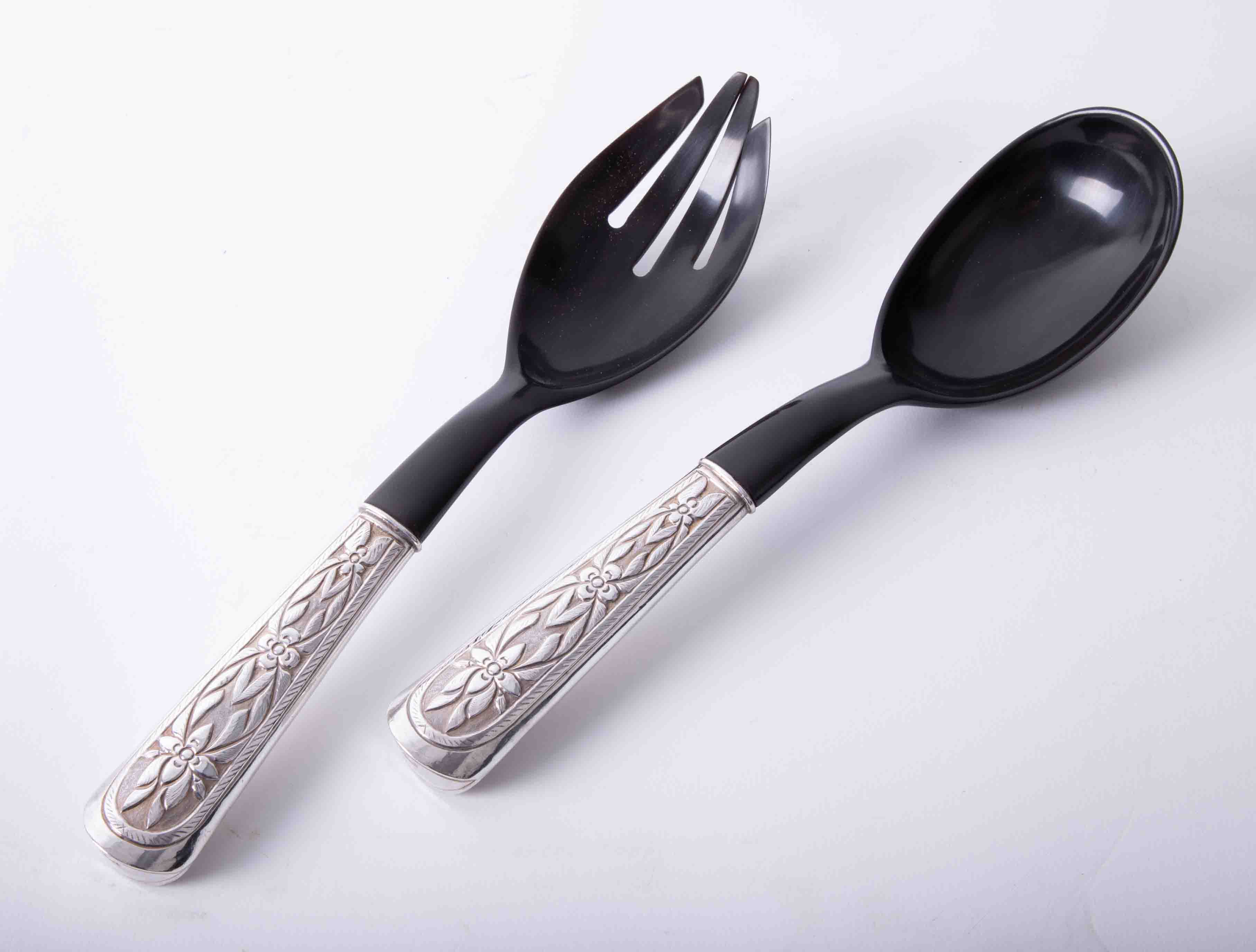 Matched pair of silver handled salad servers, each handle with embossed foliate decoration and