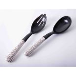Matched pair of silver handled salad servers, each handle with embossed foliate decoration and