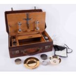 A communion cased set, fitted with an arrangement of various silver containers, EP candlesticks,