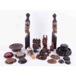 A mixed collection of African and other carvings, Oriental clock stands, face masks, etc.