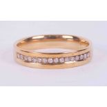 A 9ct yellow gold half eternity style ring set with 0.10 carats (total weight) of round brilliant