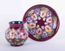 Moorcroft, a Daisy patterned vase, height 15cm, together with a matching plate, boxed.