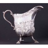 An Irish silver embossed cream jug HM West & Son, Dublin, 234gms, height 12cm.