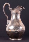 A Victorian silver cream jug, London, makers mark JH? With chased flower decoration, approx