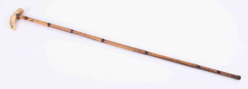 A walking cane with carved landscape knop, length 84cm.